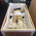 Diver suit surrounded in foam and wood by museum artifact packing service