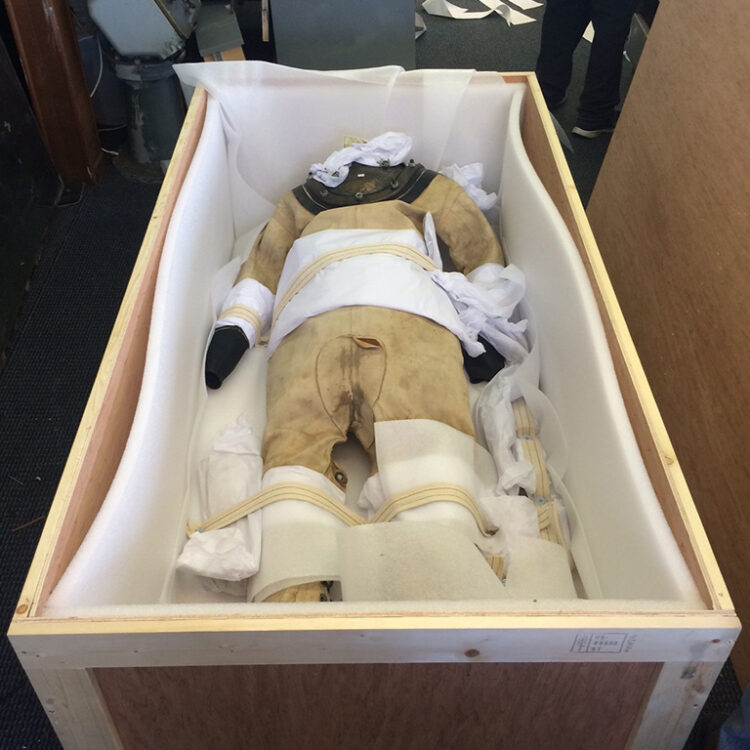Diver suit surrounded in foam and wood by museum artifact packing service