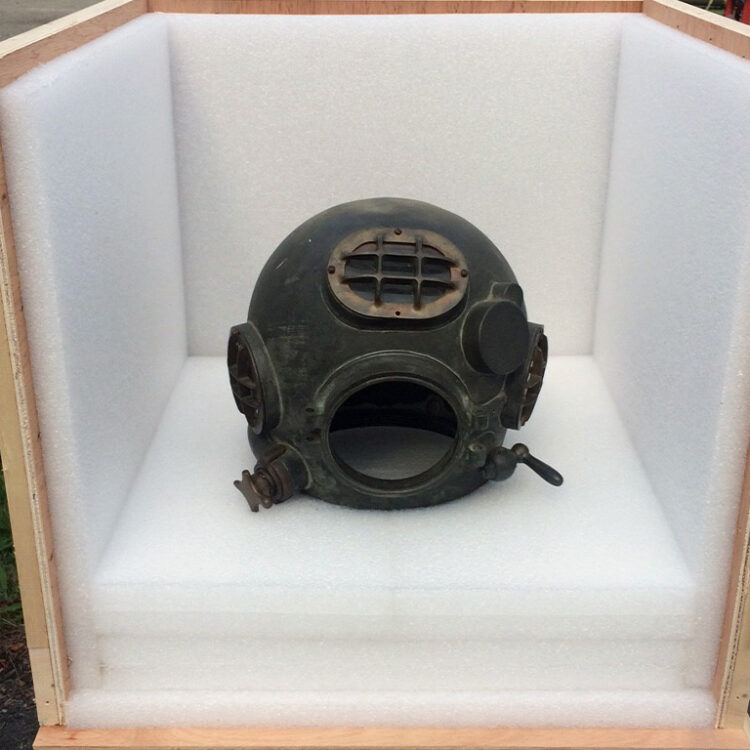 Diver helmet surrounded in foam and wood for museum artifact packing service