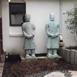 1,800 lb Chinese army general figures in garden prior to statue crating