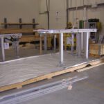 Prep work showing machinery parts on pallet being crated in warehouse for assembly line shipping