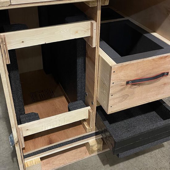 custom wood drawers lined with foam inside of a wood crate