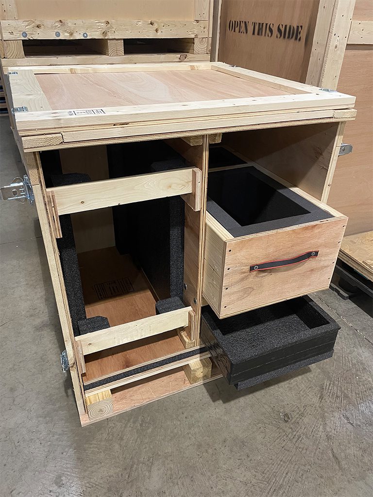 interior view of custom solid wood crate with drawers and foam lining